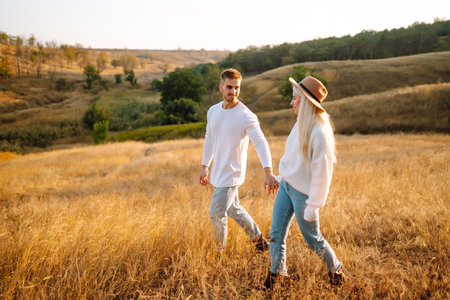 Young couple having fun walking and hugging n the park. Autumn weather. Relaxation, youth.の写真素材
