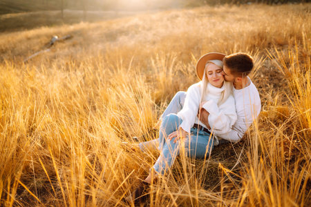 Young couple having fun walking and hugging n the park. Autumn weather. Relaxation, youth.の写真素材