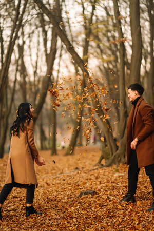 Young couple in love walking in the park on an autumn day. Enjoying time together.