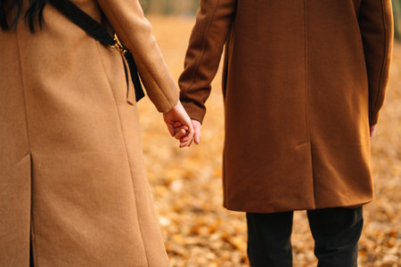 Young couple in love walking in the park on an autumn day. Enjoying time together.の写真素材