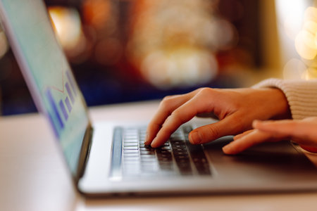 Close-up of hands working on a laptop keyboard. Freelance, online course. Shopping online.