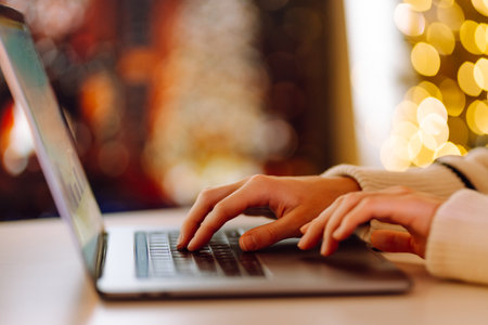 Close-up of hands working on a laptop keyboard. Freelance, online course. Shopping online.の写真素材