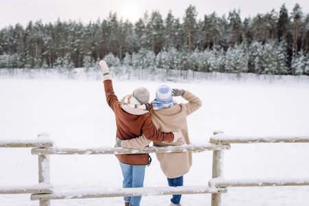 Happy friends having fun playing in winter park. Friends communicate and enjoying nature.の写真素材