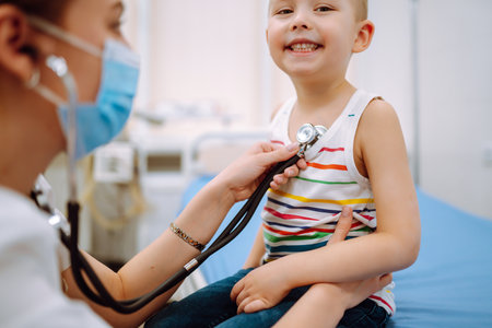 Female Doctor examining a little boy by stethoscope. ?hild's healthの写真素材