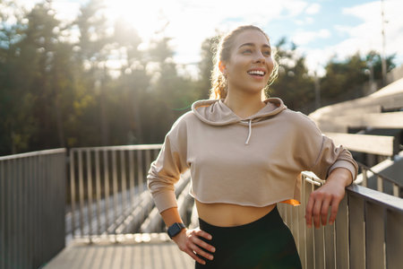 Fitness woman in fashionable sportswear is doing sports outdoors. The concept of active lifestyle.の写真素材