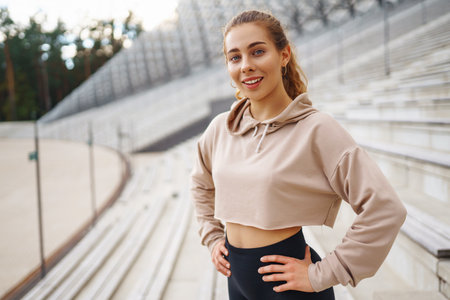 Fitness woman in fashionable sportswear is doing sports outdoors. The concept of active lifestyle.の写真素材