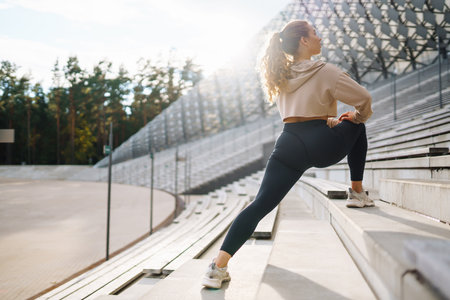Fitness woman in fashionable sportswear is doing sports outdoors. The concept of active lifestyle.