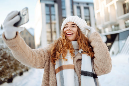 Beautiful female tourist with phone having fun outdoors. Travel concept.の写真素材