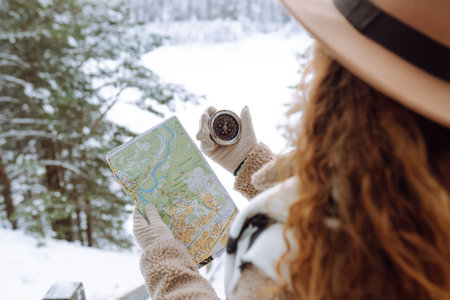 Woman is wearing a winter jacket, hat, scarf and backpack. Enjoying winter travel. Active lifestyle.