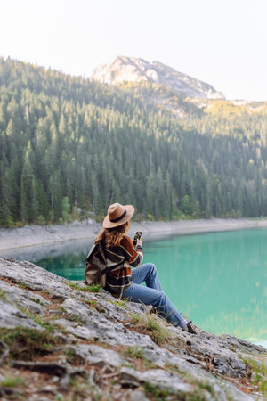 Young woman tourist uses a smartphone on the nature. Lifestyle, travel, tourism, active life.