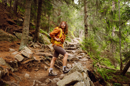 Young woman with backpack traveling outdoors. Hiking, active lifestyle.の写真素材