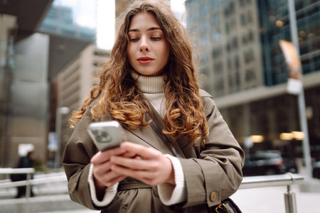 Beautiful woman using phone outdoor in street. Concept of vacation, blogging, technology, weekend.