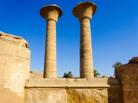 Ruins of an ancient temple of Egypt with statues and columnsの写真素材