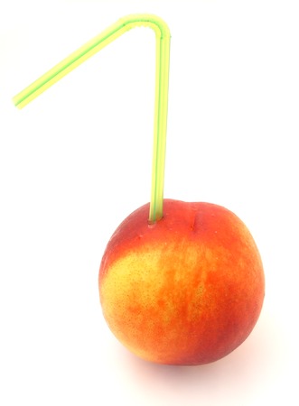tube in ripe nectarine isolated on white backgroundの写真素材