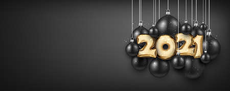 Golden foil balloon 2021 sign with snow on black background. Black christmas tree toys hanging on...