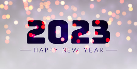 Banner with 2023 happy new year sign on sweaty grass on colorful bokeh lights background.