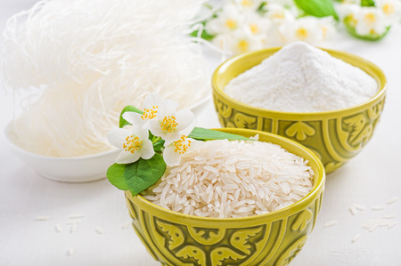 Bowls of rice and rice flour and jasmine flowerの写真素材