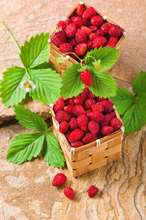 Strawberries in a baskets on a stoneの写真素材