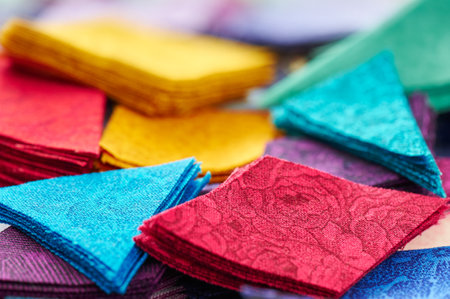 Pile stacks of triangle and diamond pieces of colorful bright fabrics for making quiltの写真素材