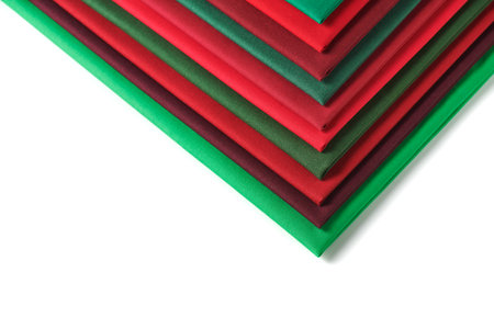 Stack of red and green fabrics on white background, space for textの写真素材