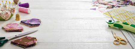 Stacks of multi-colored pieces of fabric, sewing and quiltig accessories. Traditional patchwork. Space for textの写真素材