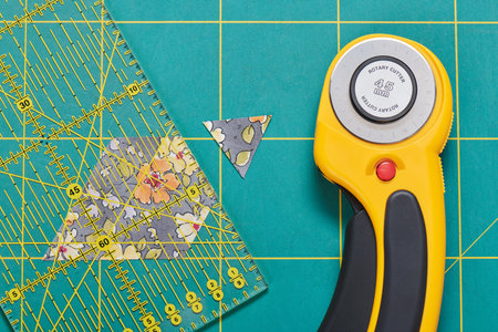 The process of cutting pieces of fabric in the shape of hexagons to create a quiltの写真素材