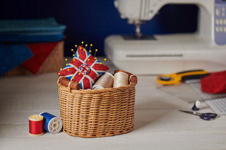 Pincushion like Union Jack in a wicker basket, sewing machine, sewing accessoriesの写真素材
