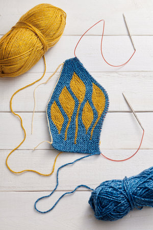 The process of knitting a hat with circular knitting needles using the short rows methodの写真素材