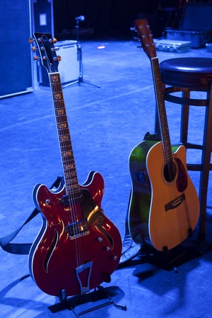 Guitar and other musical equipment on stage before concertの写真素材