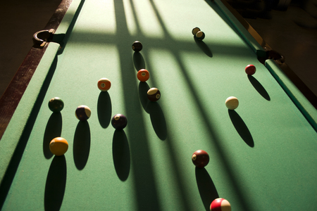 Sharp shadows on the billiard table from the balls.の写真素材
