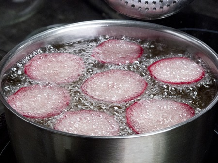 Vegetable oil is boiling in a steel pan.の写真素材