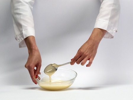 Female hands with kitchen objects on a white background.の写真素材