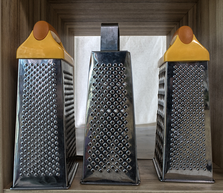 Kitchenware on wooden shelves. Group of stainless steel kitchenware.の写真素材