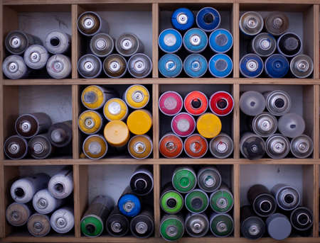 cans of paint are stacked on a shelf.の写真素材