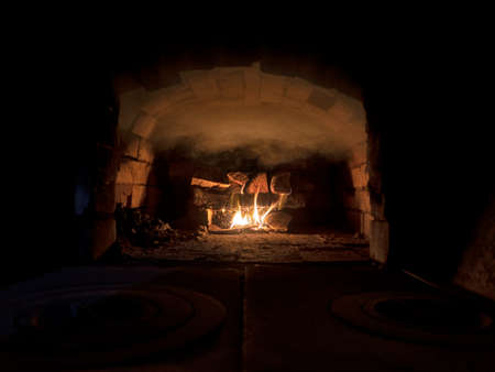 Russian interior oven with an oven and a burning fire, covered with texture