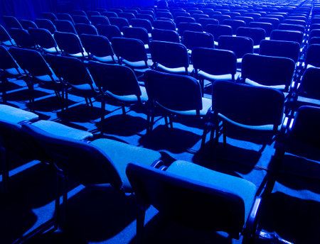 blue chair seats in an empty conference room.
