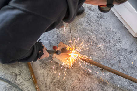 welding metal pipe by acetylene gas burner close up.