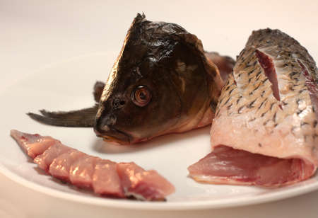 Raw fish. Fish prepared for cooking. Fish and spices on a wooden table.の写真素材