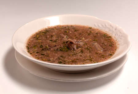 Close up soup in bowl over light stone background. Healthy diet dish for dinner.
