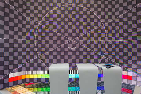 A man on the background of a television LED screen with a technical table.の写真素材