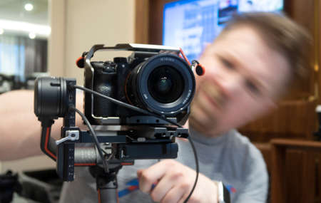 photographer with a camera at work, close-up. Professional Photographer Work Kit. Photo Lenses.