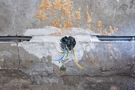 New electrical installation, socket and electrical cables on the wall, renovation conceptの写真素材