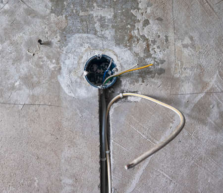 New electrical installation, socket and electrical cables on the wall, renovation concept
