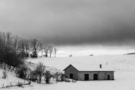 A small mountain retreat covered by snow on Mt. Subasio (Umbria, Italy) during winter seasonの写真素材