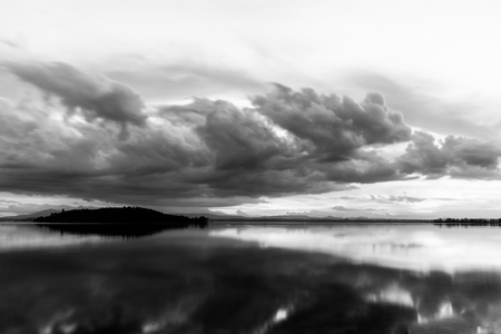 Perfect and symmetric clouds reflections on a lakeの写真素材