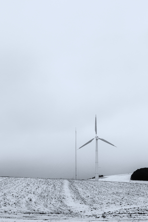 A wind turbine on a mountain covered by snow near Colfiorito town (Umbria, Italy)