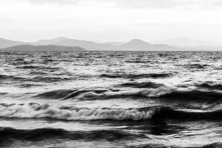 Details of waves in a lake, with distant hills in the backgroundの写真素材