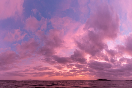 A lake at dusk, with beautiful, warm tones in the sky, clouds anの写真素材