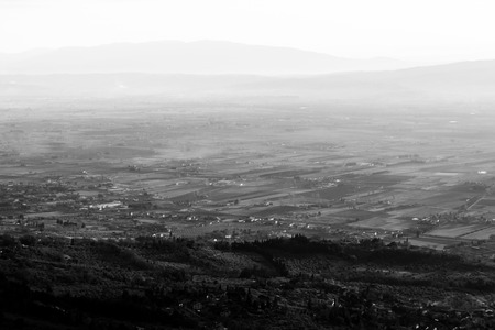 A valley in Umbria at sunset, with mist, close and distant hillsの写真素材