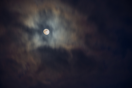 Full moon in the middle of clouds